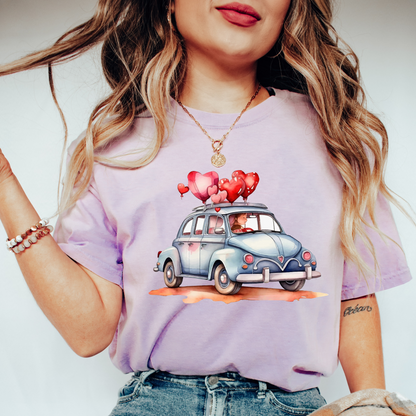 a woman wearing a t - shirt with a car with hearts on it
