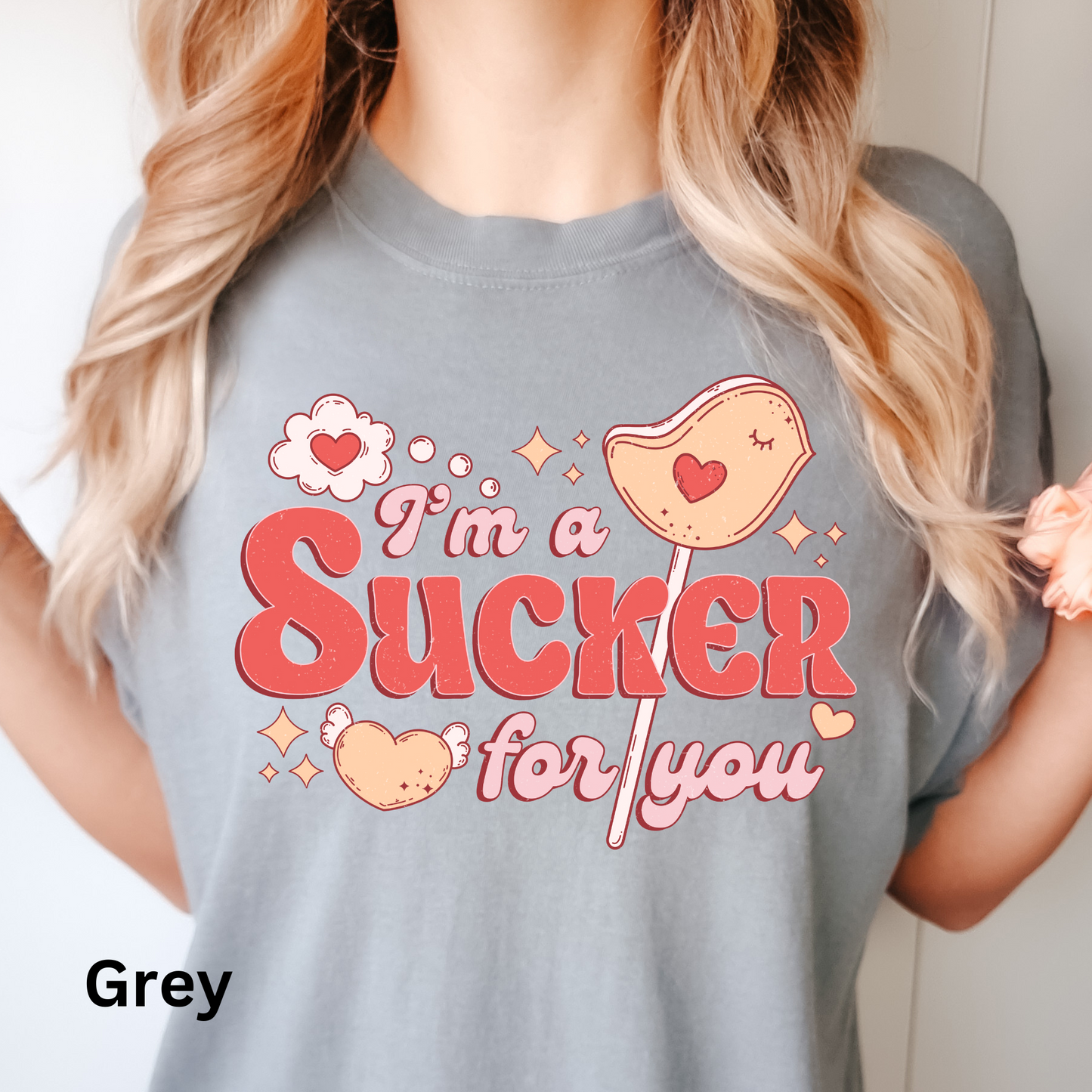 a woman wearing a t - shirt that says i'm a sucker for you