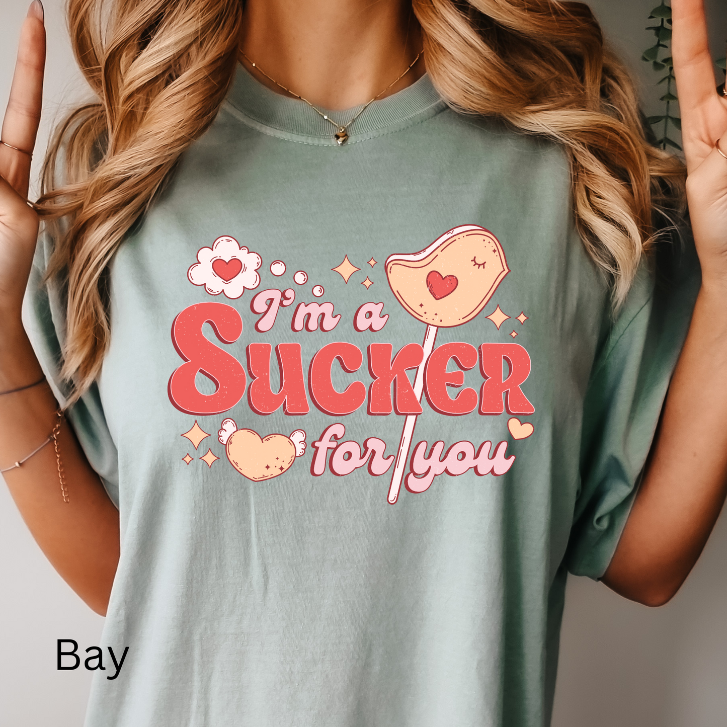a woman wearing a t - shirt that says i'm a sucker for you