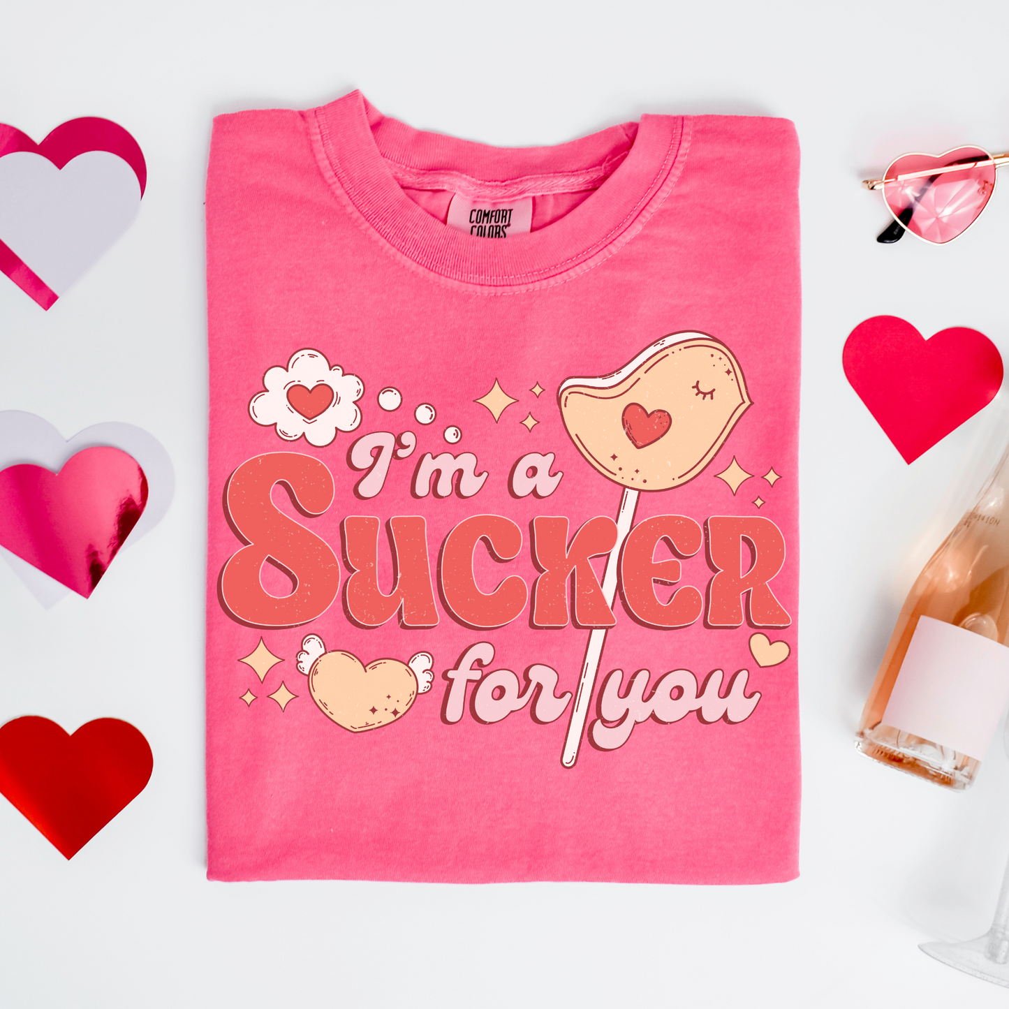 a pink t - shirt that says i'm a sucker for you