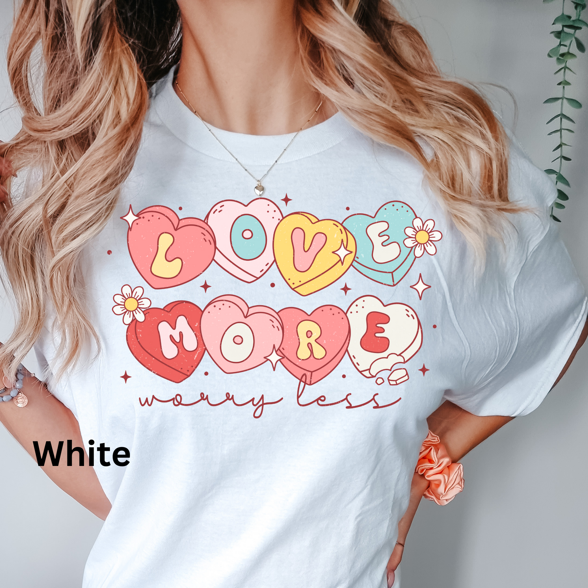 a woman wearing a t - shirt that says love more