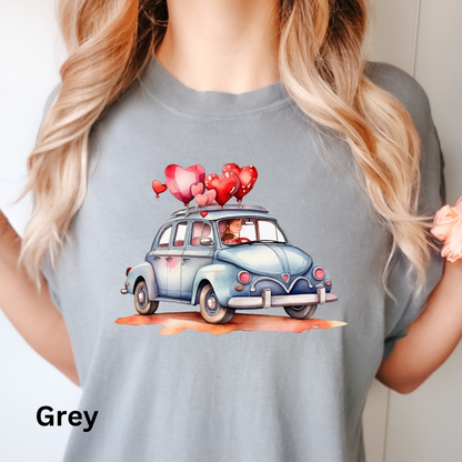 a woman wearing a t - shirt with a picture of a car with hearts on