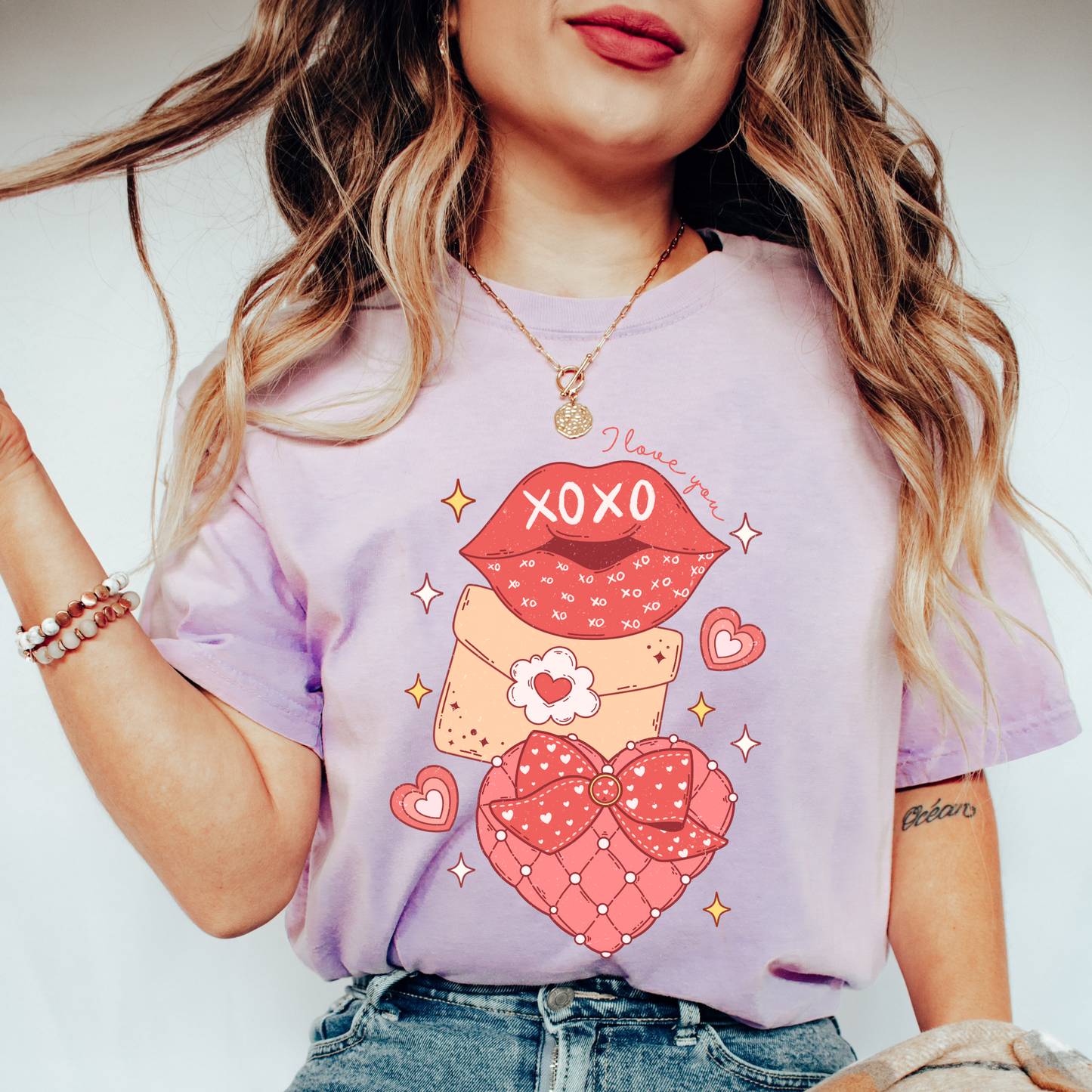 a woman wearing a shirt with a picture of a teddy bear on it