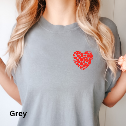 a woman wearing a grey shirt with a red heart on it